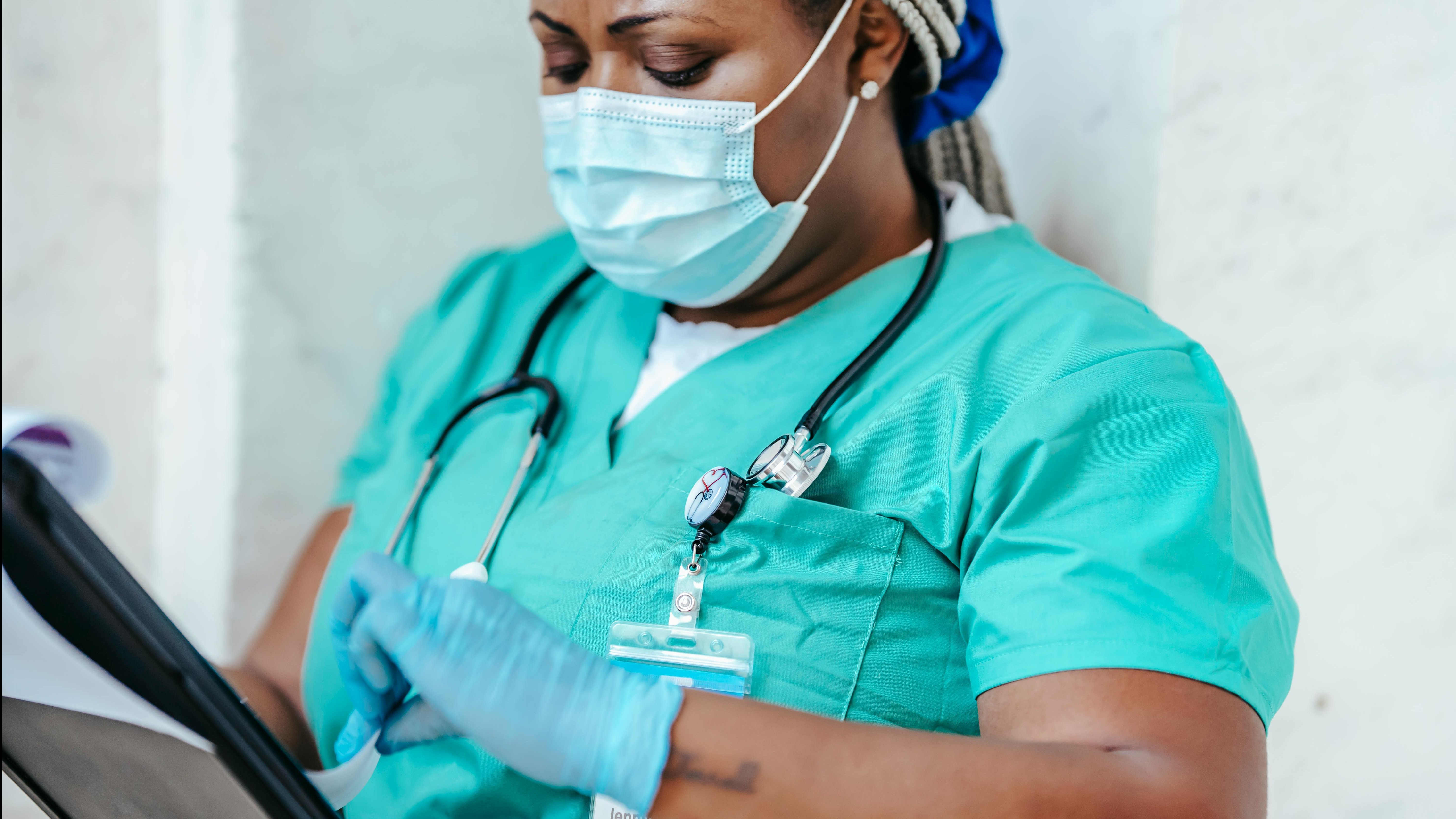 Nurses discussing antibiotic pharmacology in a hospital.