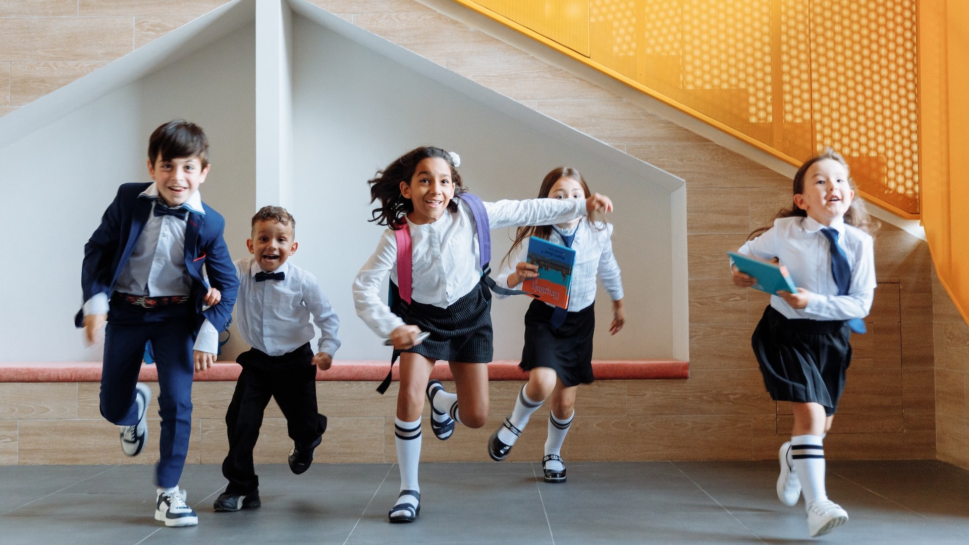Kids running out of school to enjoy their school holiday bouncy castle hire.