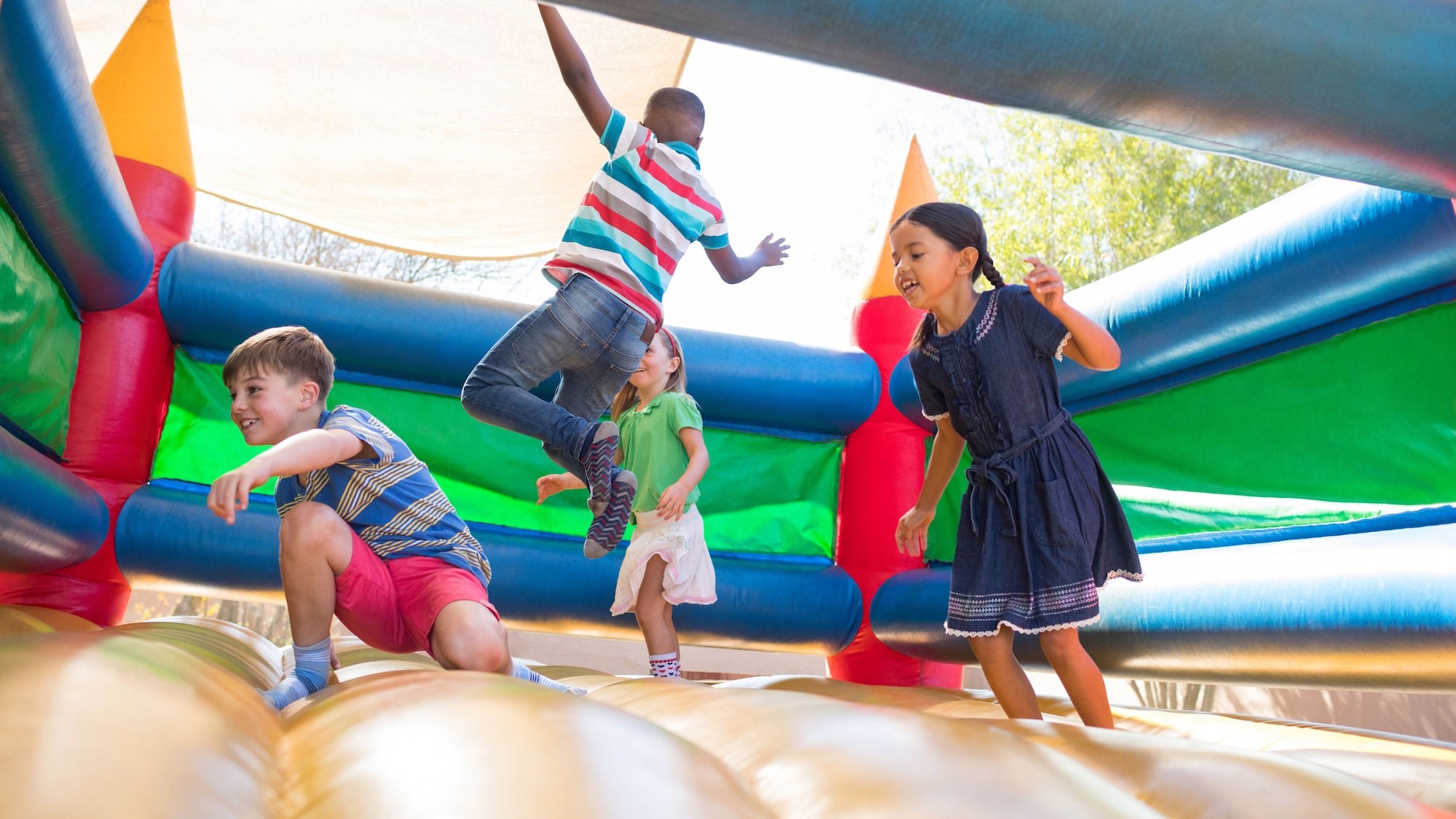 Children enjoying a bouncy castle thanks to no deposit booking with Monster Inflatables