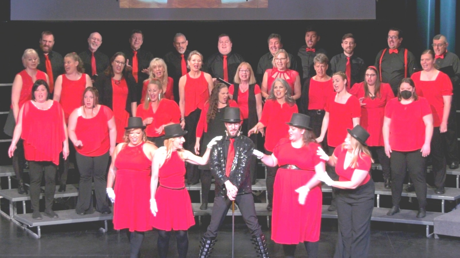 Diverse adults auditioning for musical theatre on stage under dramatic lights