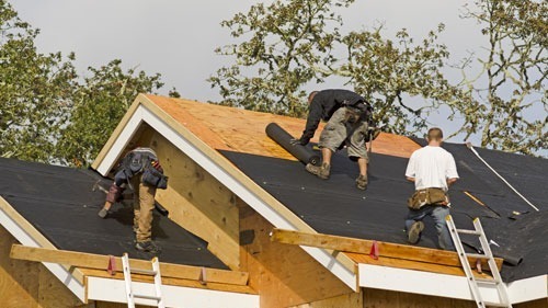<img src="roofing.jpg" alt="men putting on tar paper for a new roof">