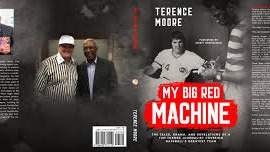 Library scene with man displaying 'My Big Red Machine' books.