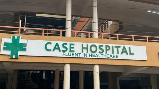 Fluent in healthcare: Case Clinic hospital exterior in Kampala Uganda with vibrant tropical setting