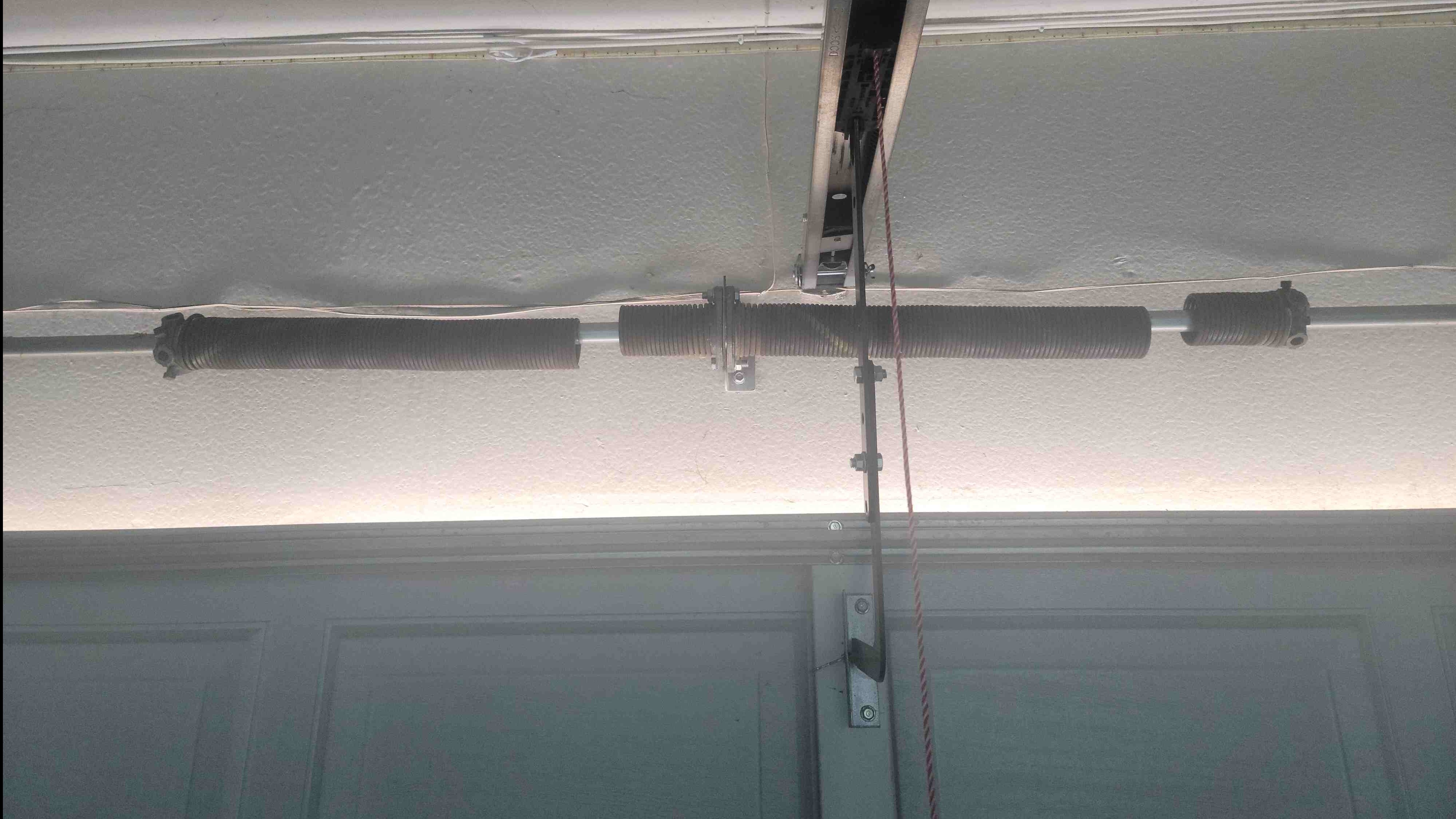 Picture of 2 broken torsion garage door springs
