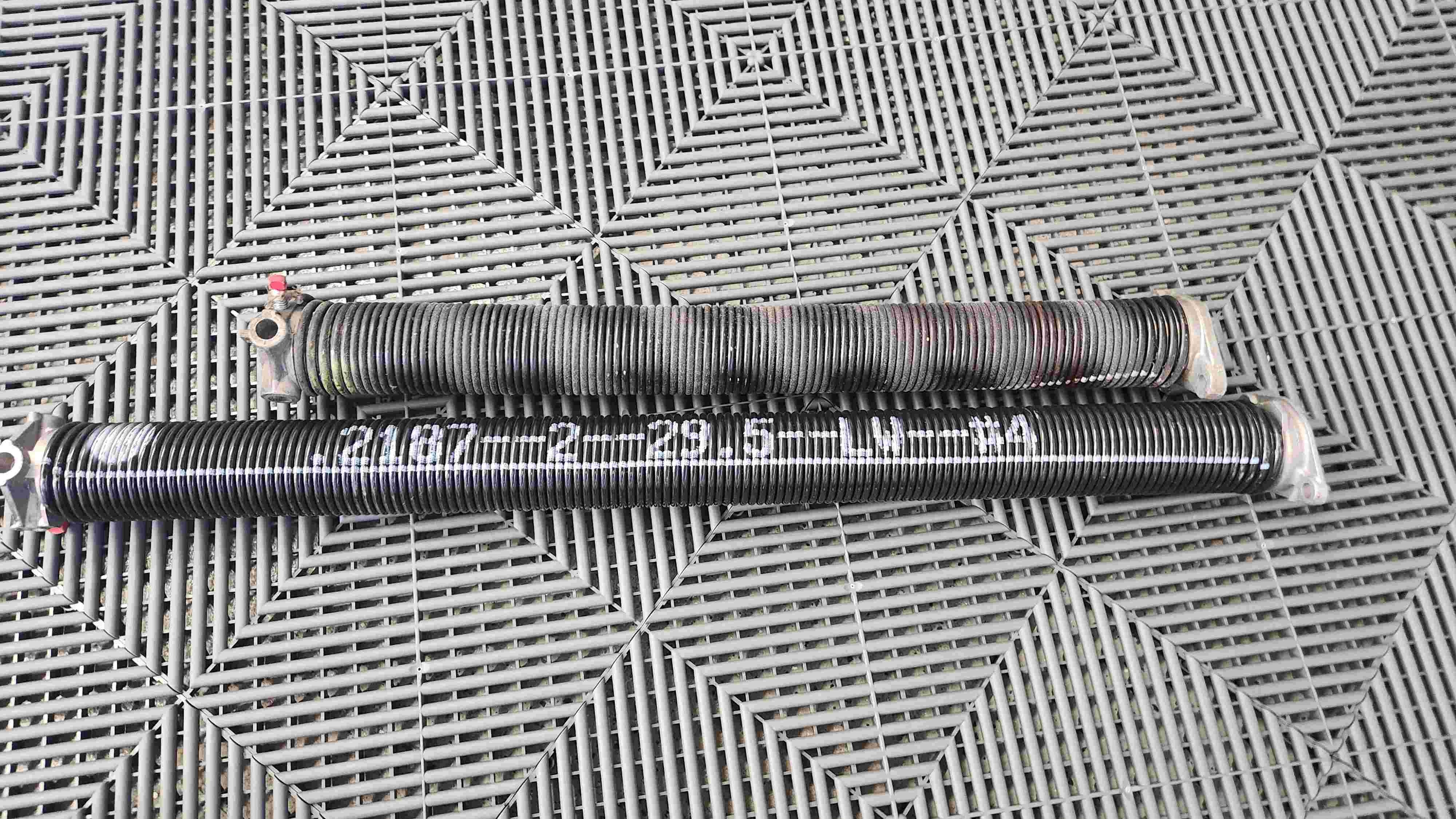 Close up of 2 different springs with the same lifting power, but different life cycle length