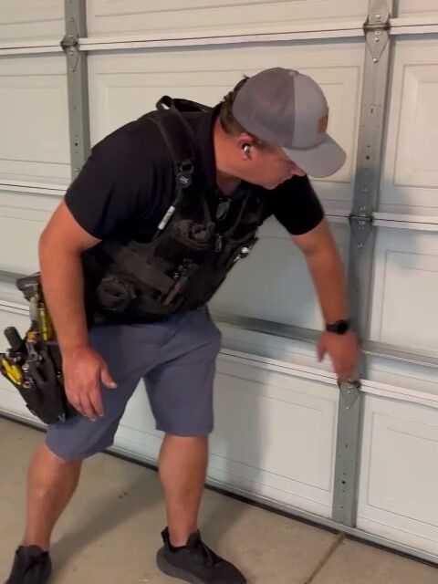 Organized set of professional garage door repair tools prepared for safe garage door spring replacement, with technician.