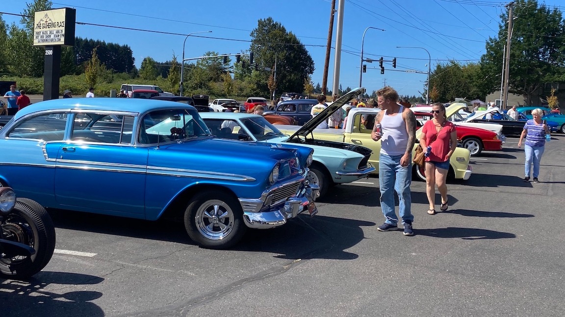 people looking at blue classic car at car show