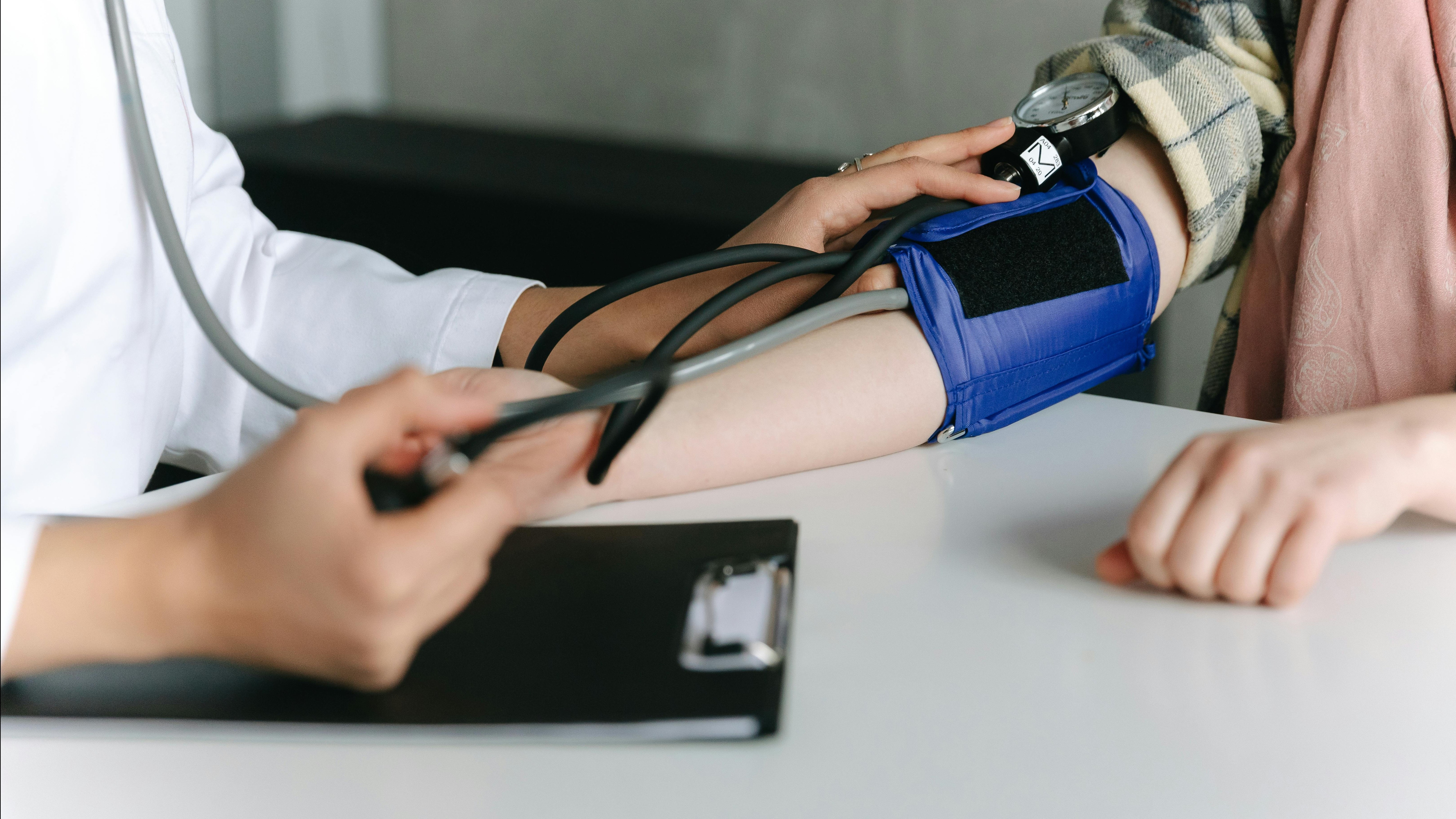 doctor holding blood pressure cuff on arm, CU
