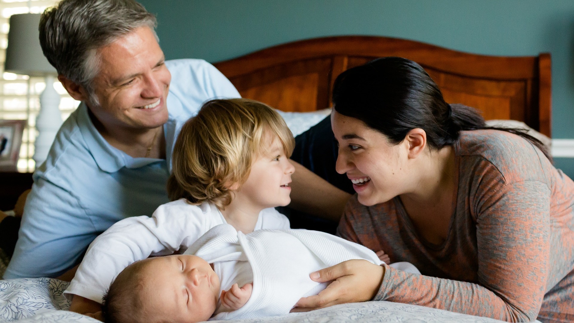 Happy family on a bed