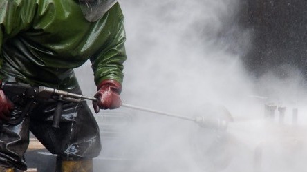 Man cleaning with pressure washer