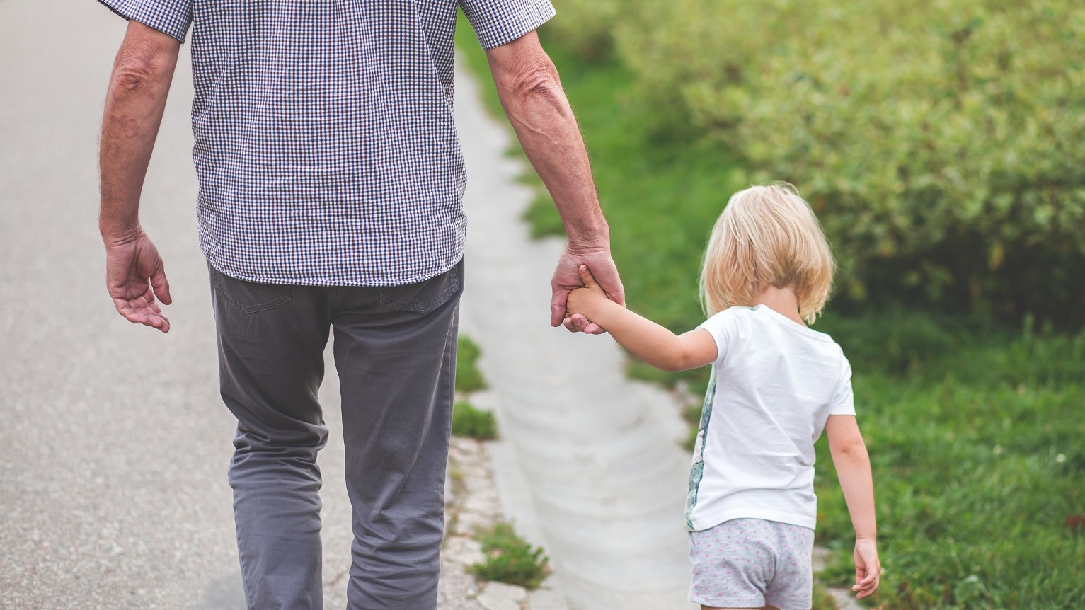 Grandparent walking his child