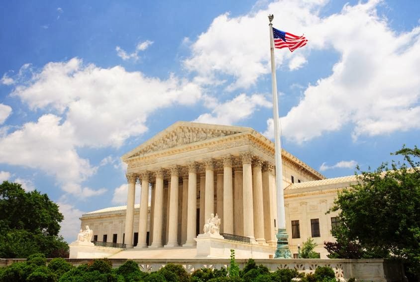 Outdoor picture of courthouse with american flag