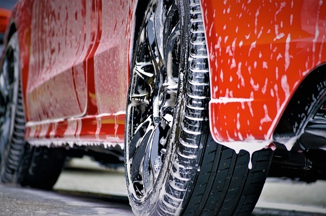 Sideskirt of vehicle soaked in soap at car wash