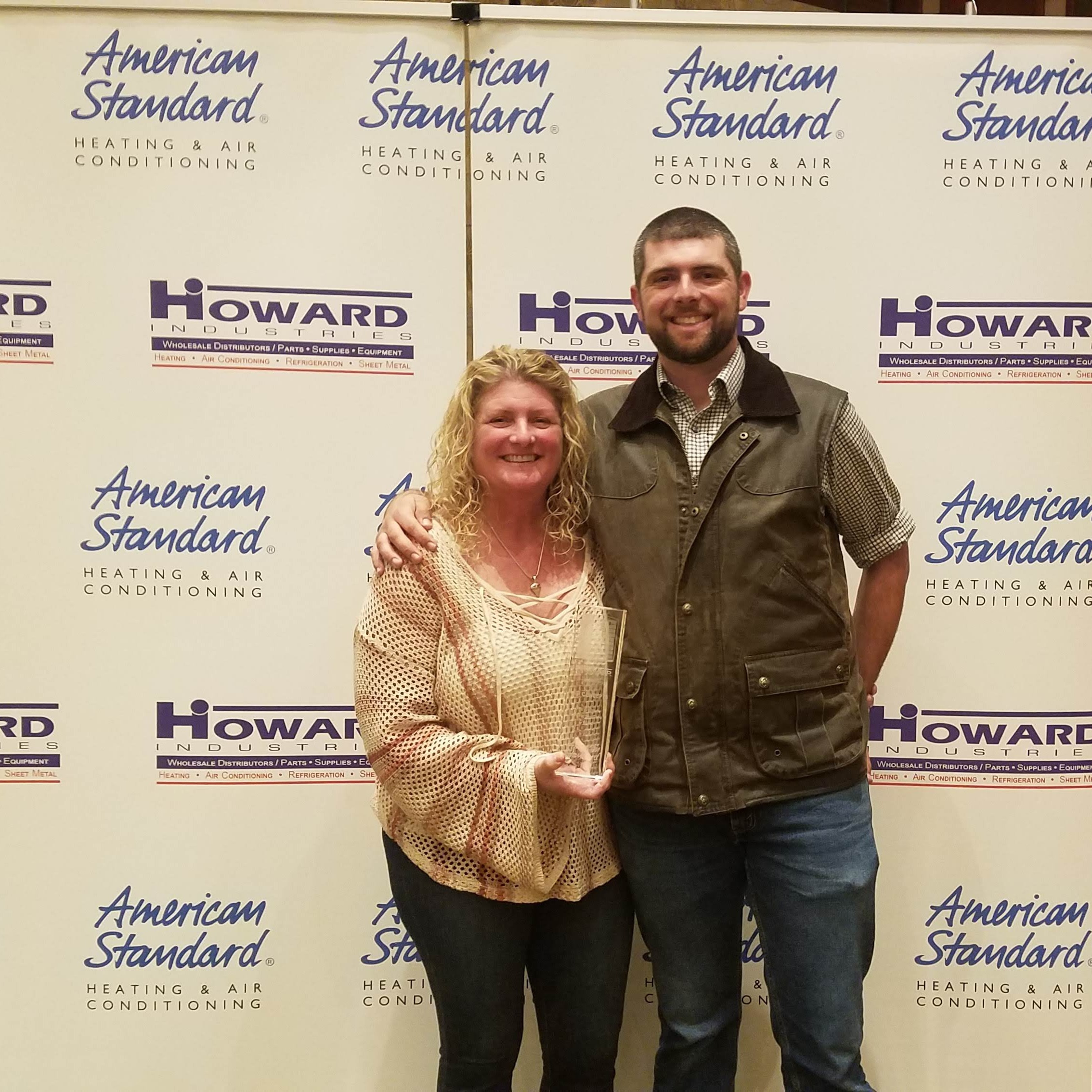 Picture of Kelly standing next to her son smiling