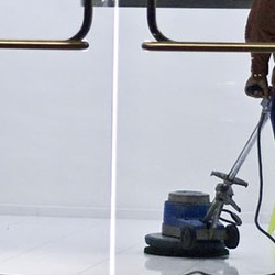 Floor being waxed by a technician