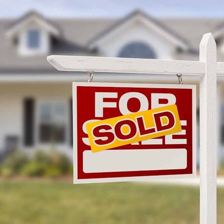For Sale Sign with SOLD sticker overtop