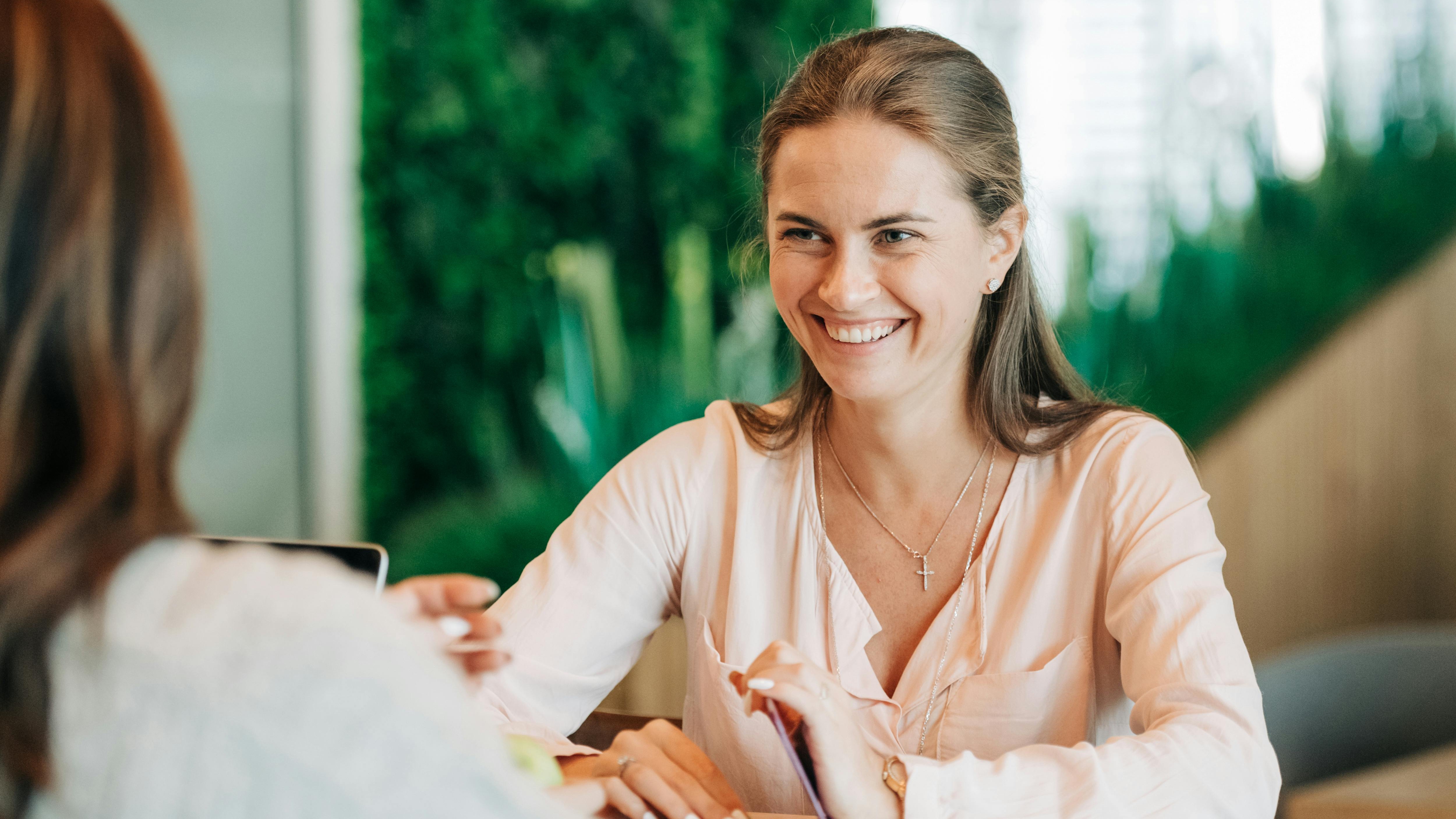 young financial consultant, concentrated look, discussing retirement solutions, photorealistic, comfortable home office with books and plants, highly detailed, window breeze catching paper, 12K resolution, earthy tones, side lighting, shot with a 100mm lens.