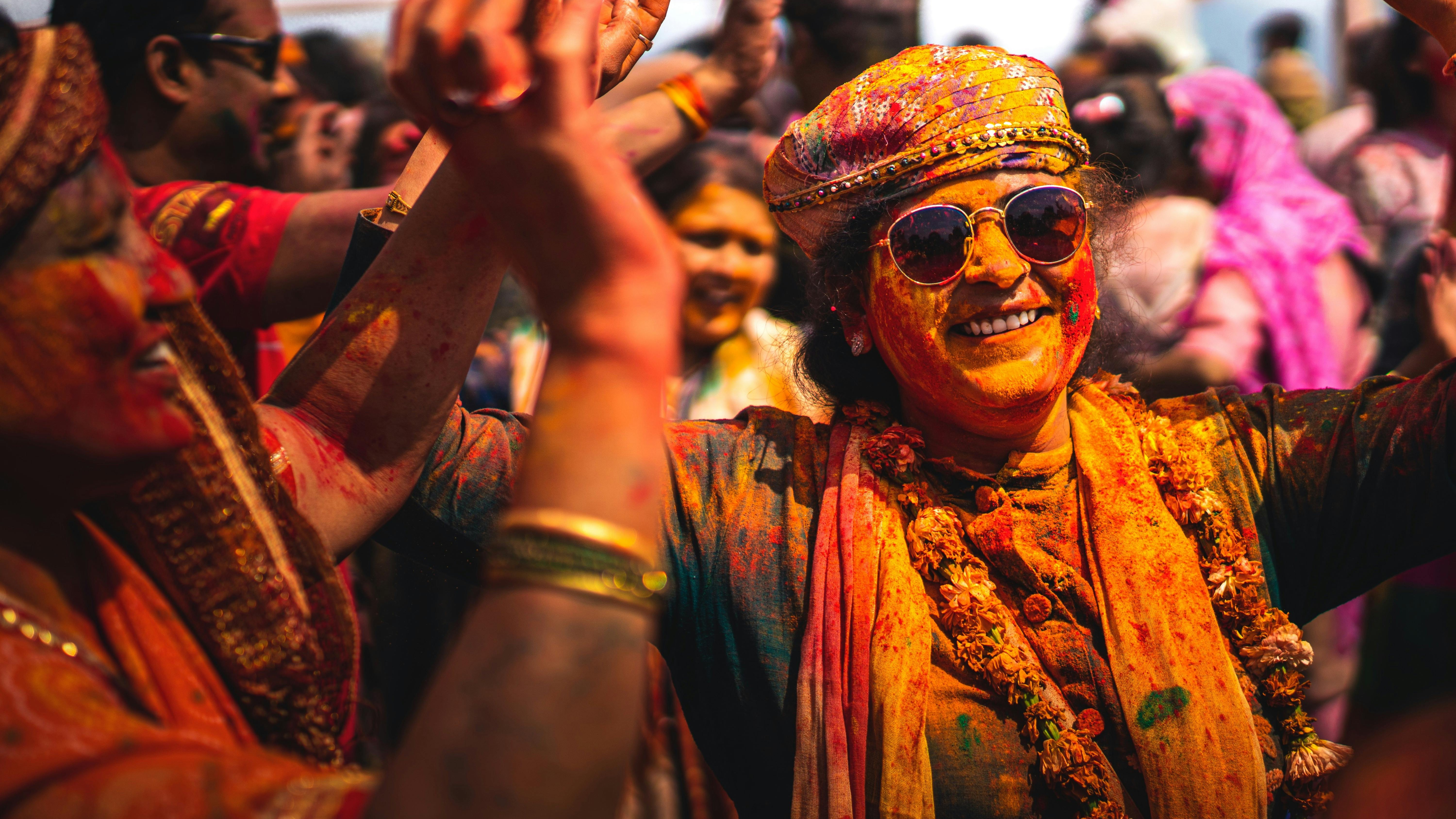 Vibrant Indian baraat celebration with dancing people and colorful outfits.
