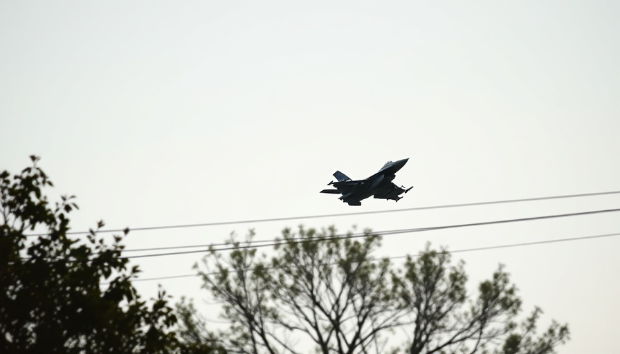 Military jet in clear sky, related to Ukraine weapons plan.