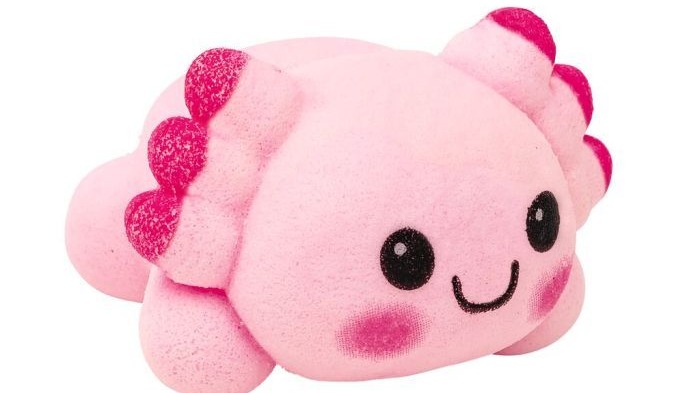 Cute axolotl toy with colorful coral in underwater theme.