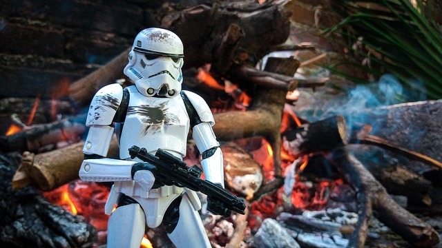 Elegant couple posing at Star Wars event, showcasing joy and elegance.