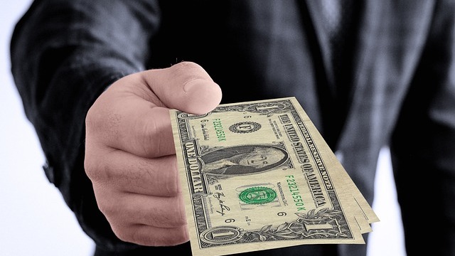 Complex currency reflection through a crystal ball, highlighting employer compensation challenges.