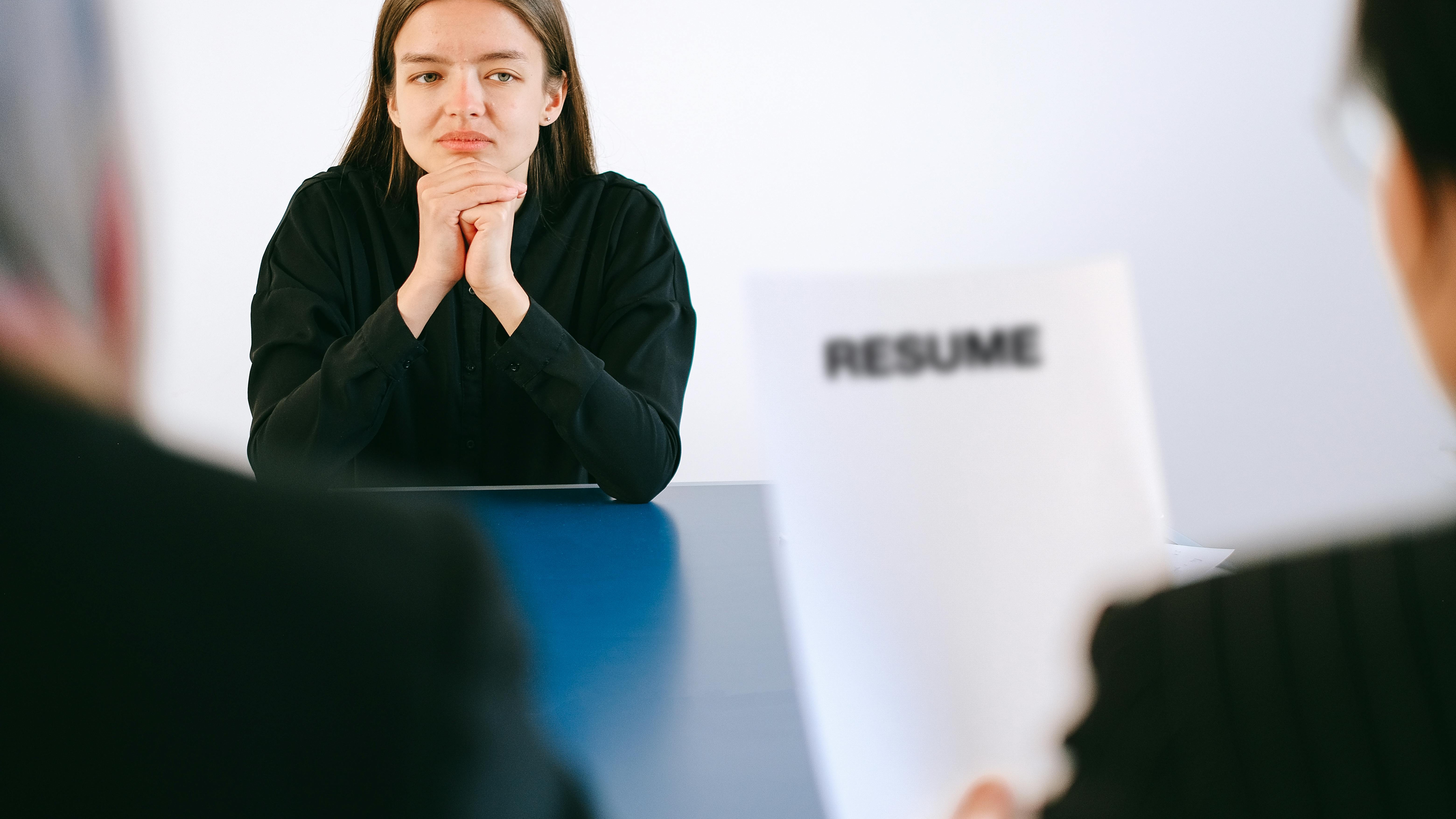 Professionals discussing hiring trends in modern office, smiling.