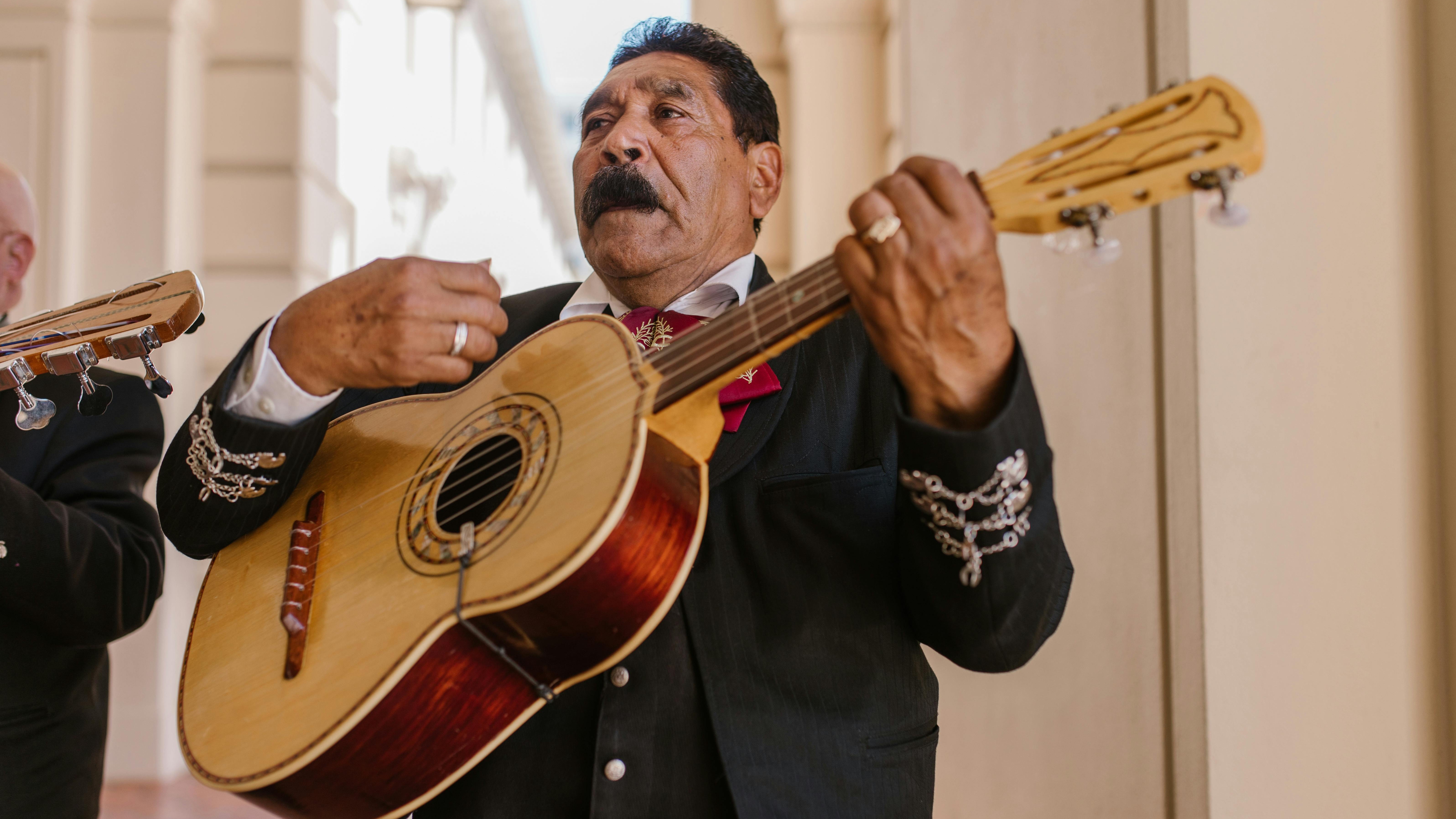 Mariachi band performing outdoors, lively San Antonio family activities scene.