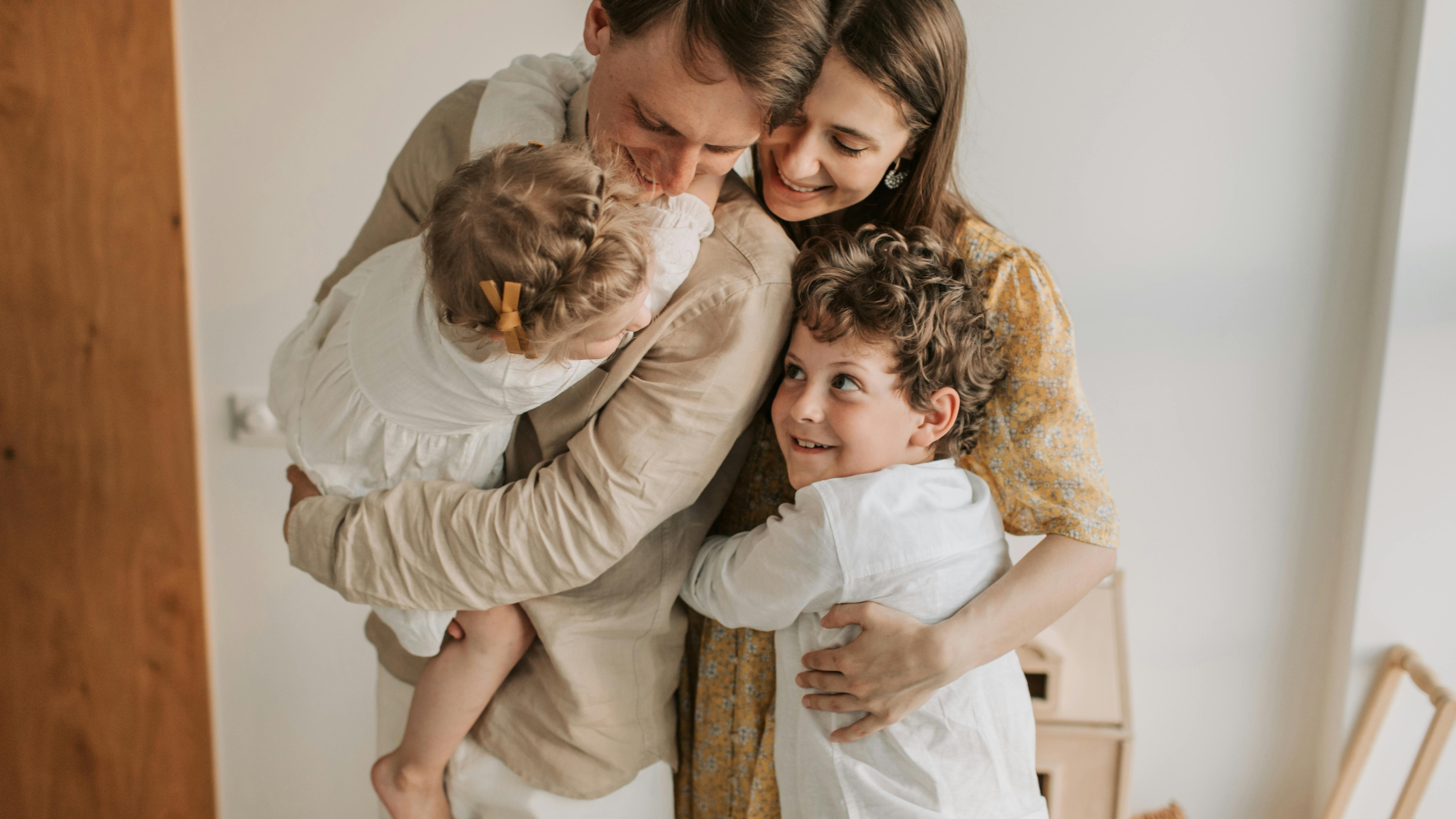 Young family engaging in emotional intelligence parenting in a cozy home.