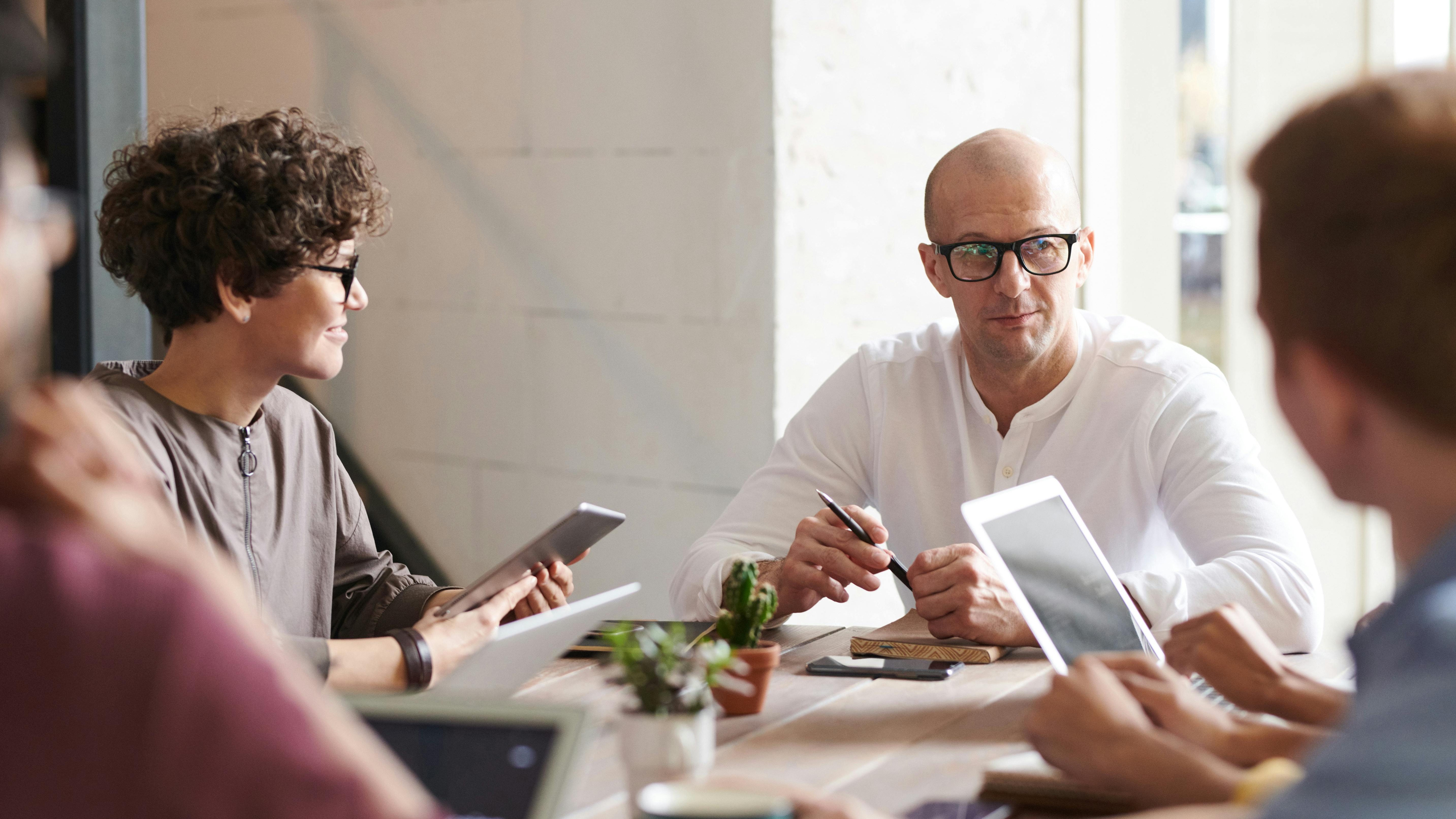 Diverse team collaborating in a modern office, showcasing workplace culture transformation.