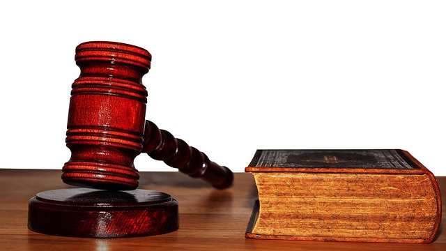 California Captive Audience Ban examination with law text and magnifying glass.