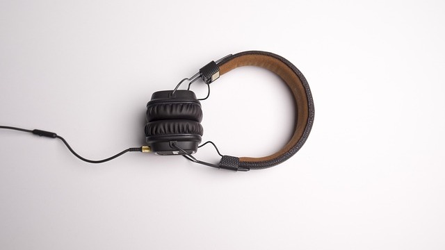DJ using RØDE NTH-50 On-Ear Headphones in a lively club setting.