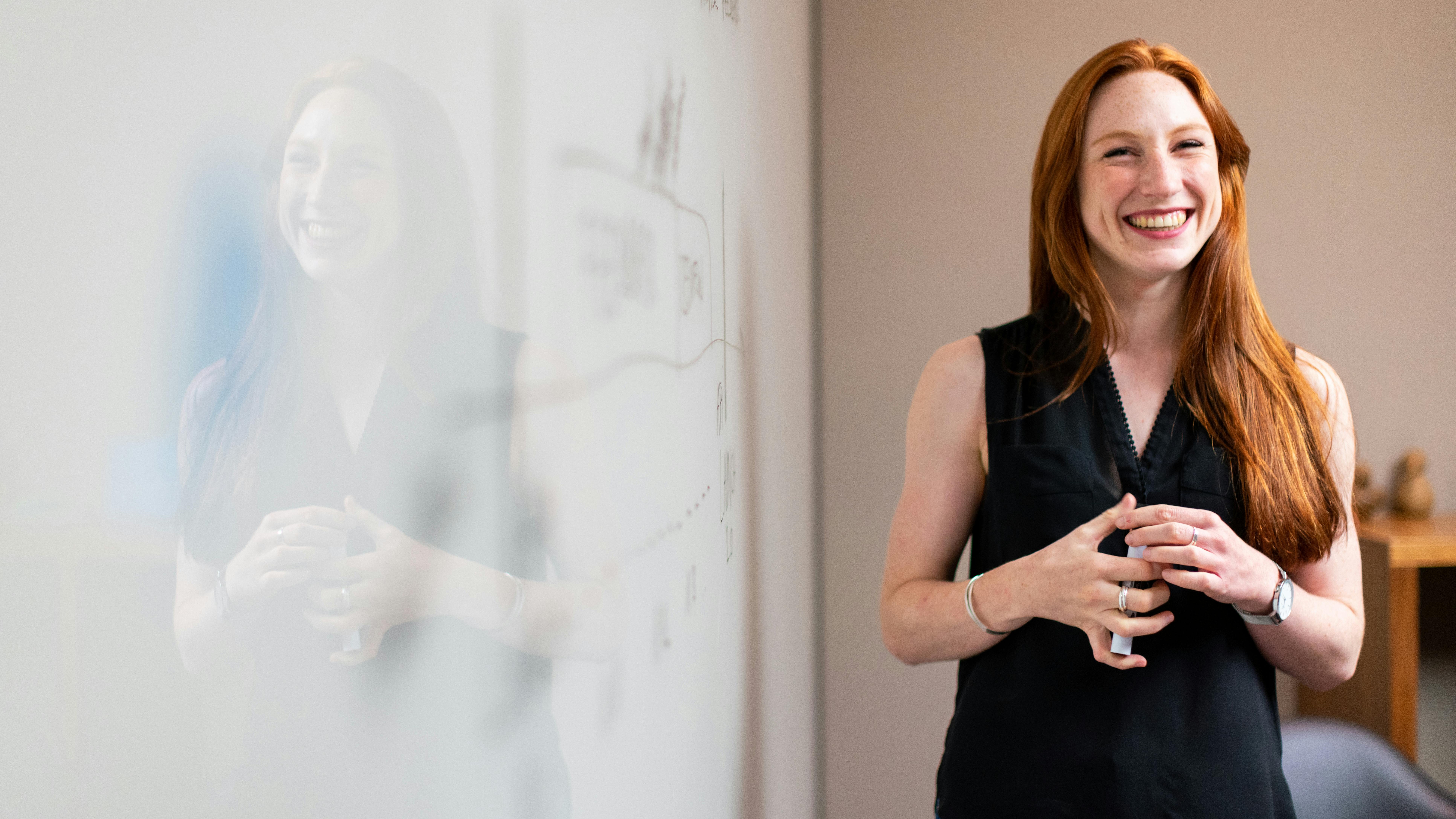 Portrait of a confident female executive leader with a purple background.
