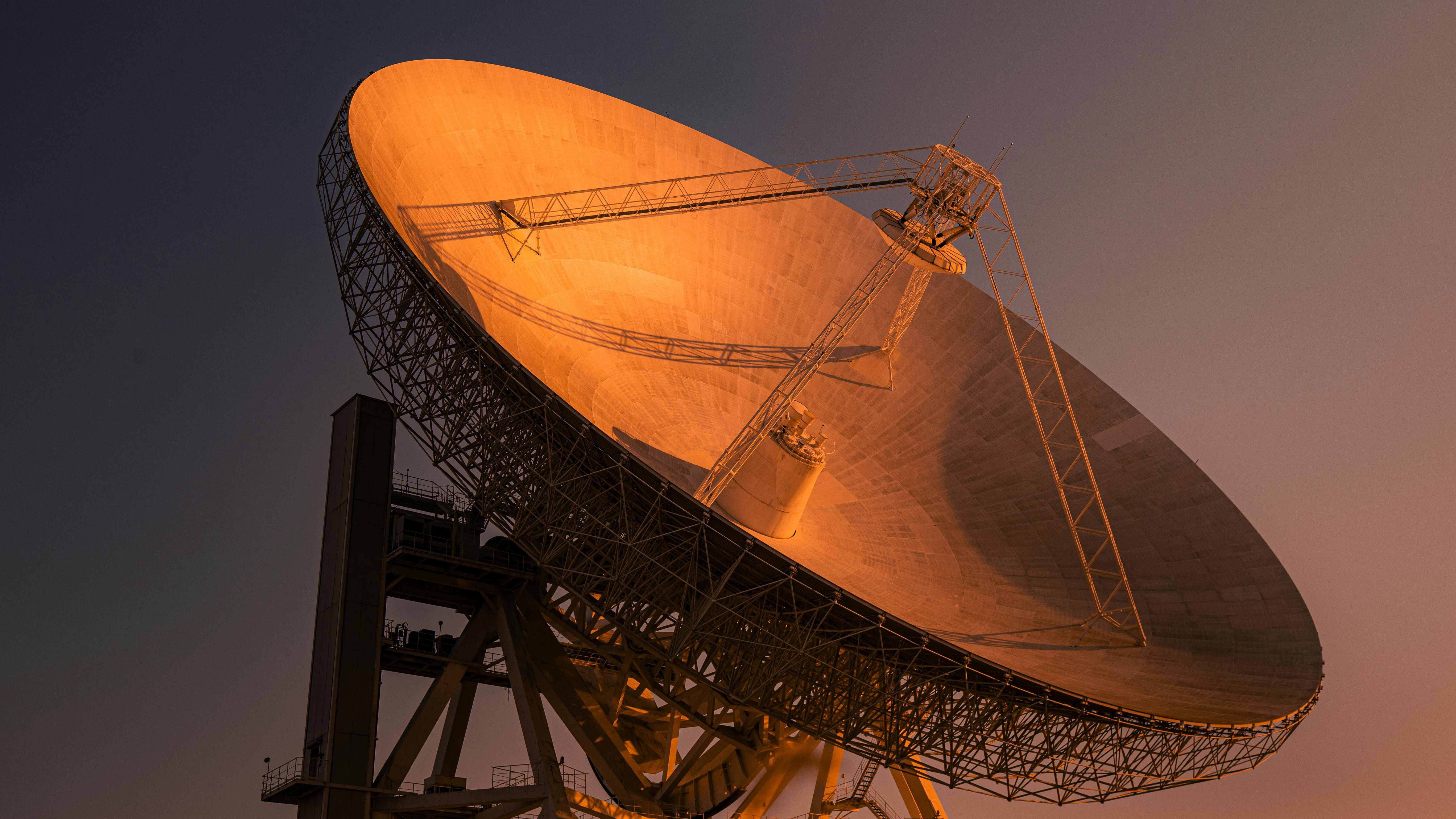 Cosmic scene with satellite and dishes, Best Satellite Internet Providers context.
