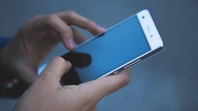 Woman frustrated with 5G home internet on smartphone in home office
