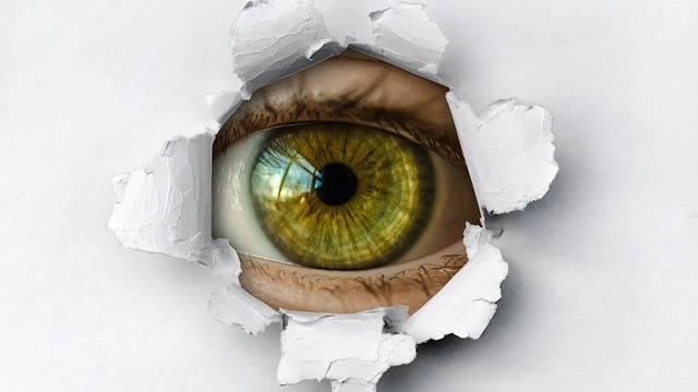 Smart home hacking risks depicted by a mysterious hacker in shattered glass.