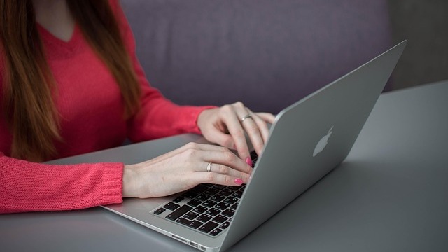 Laptop displaying artistic wallpaper, Mac malware protection tips.