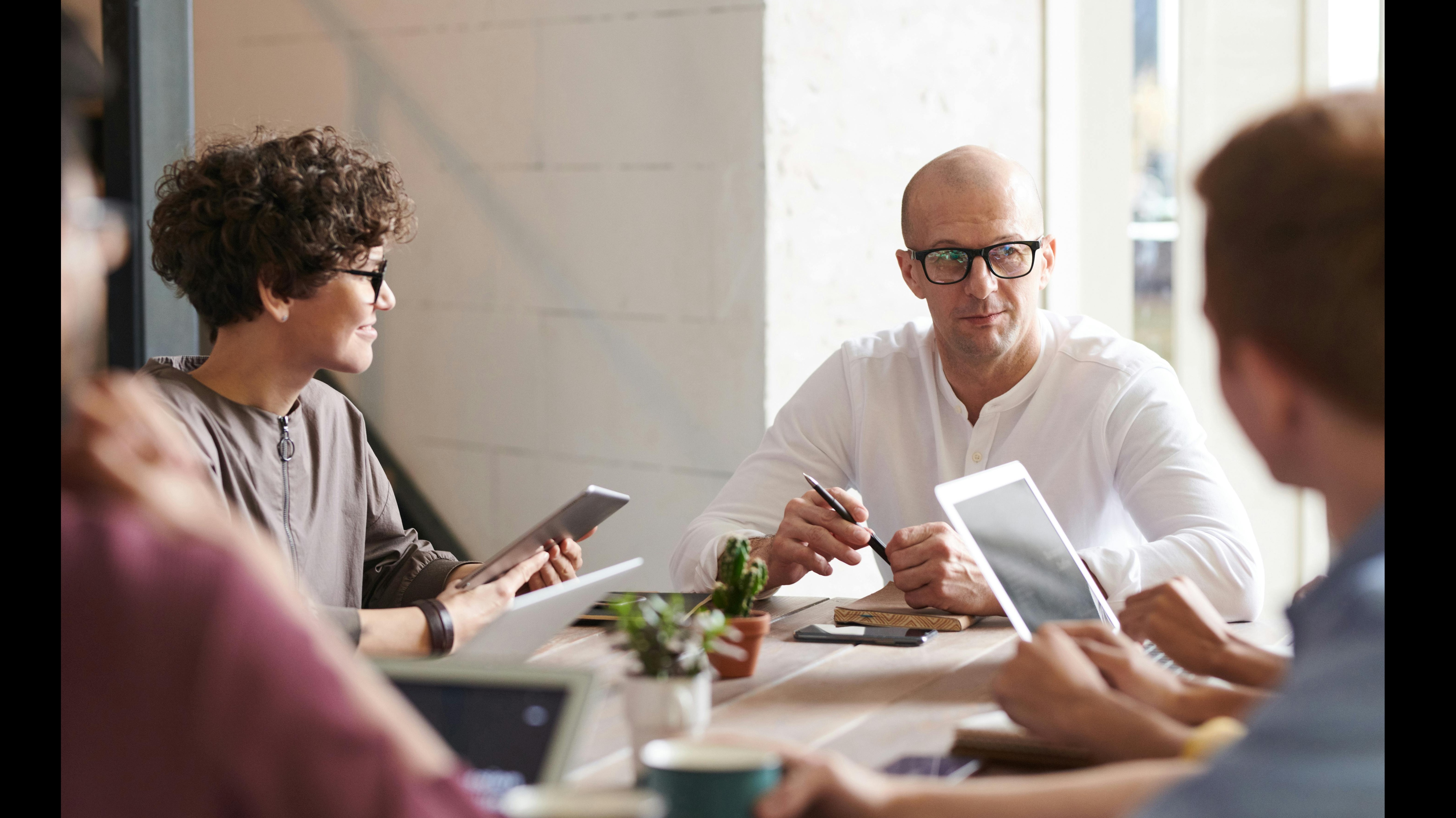 Inclusive workplace culture with a casually dressed smiling woman working at a desk.