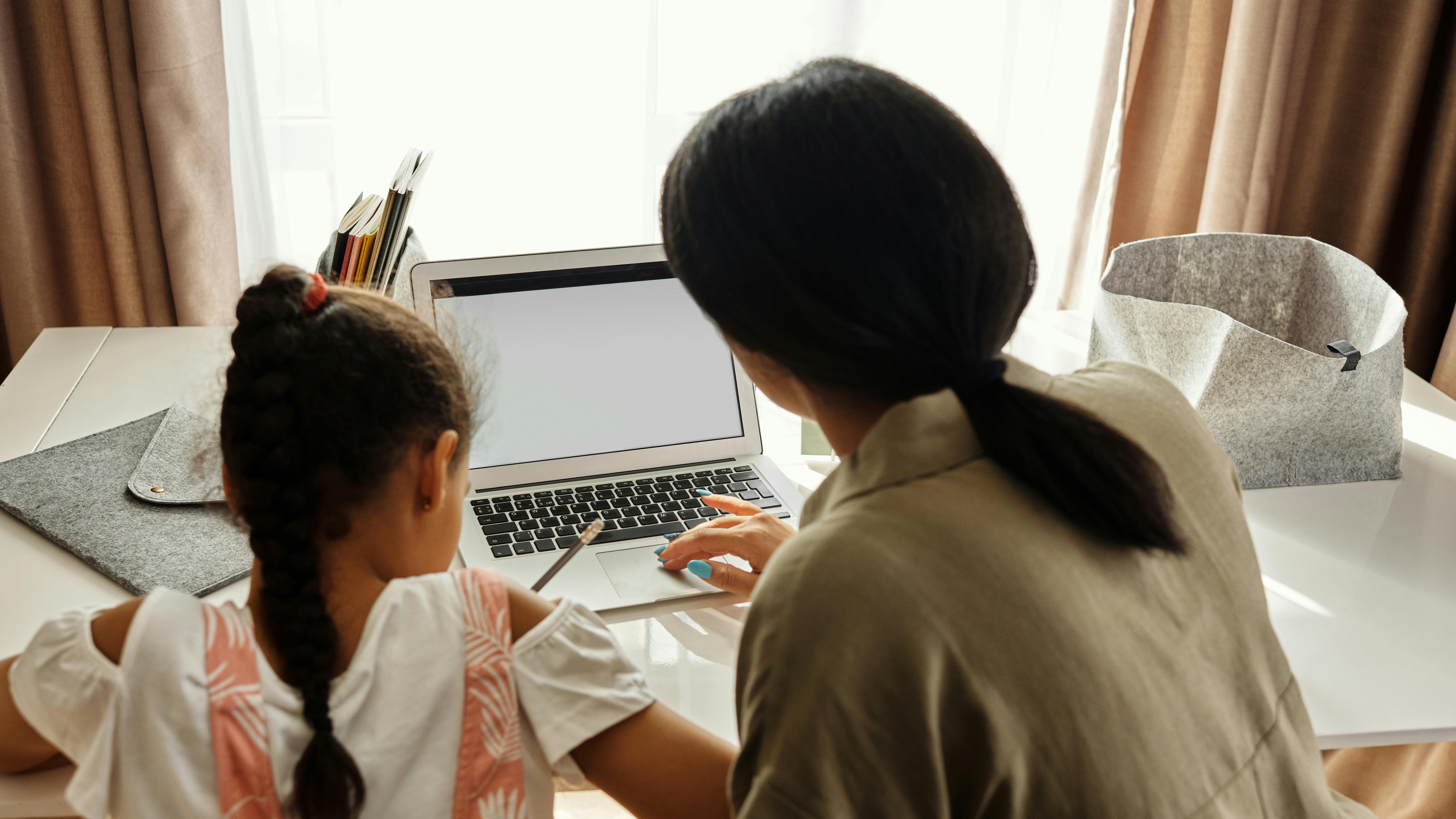 Father helps daughter prepare for school morning routine.