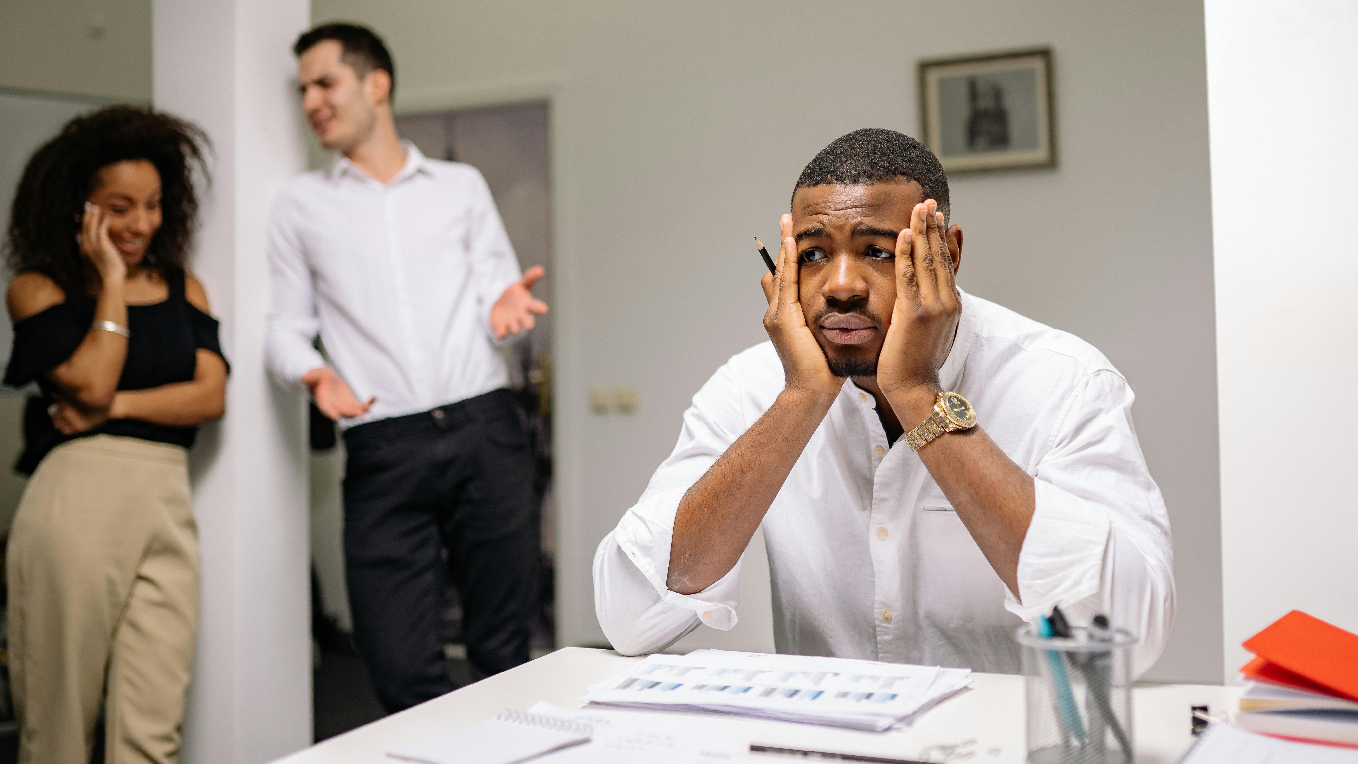 Heated office discussion among professionals, highlighting workplace tension.