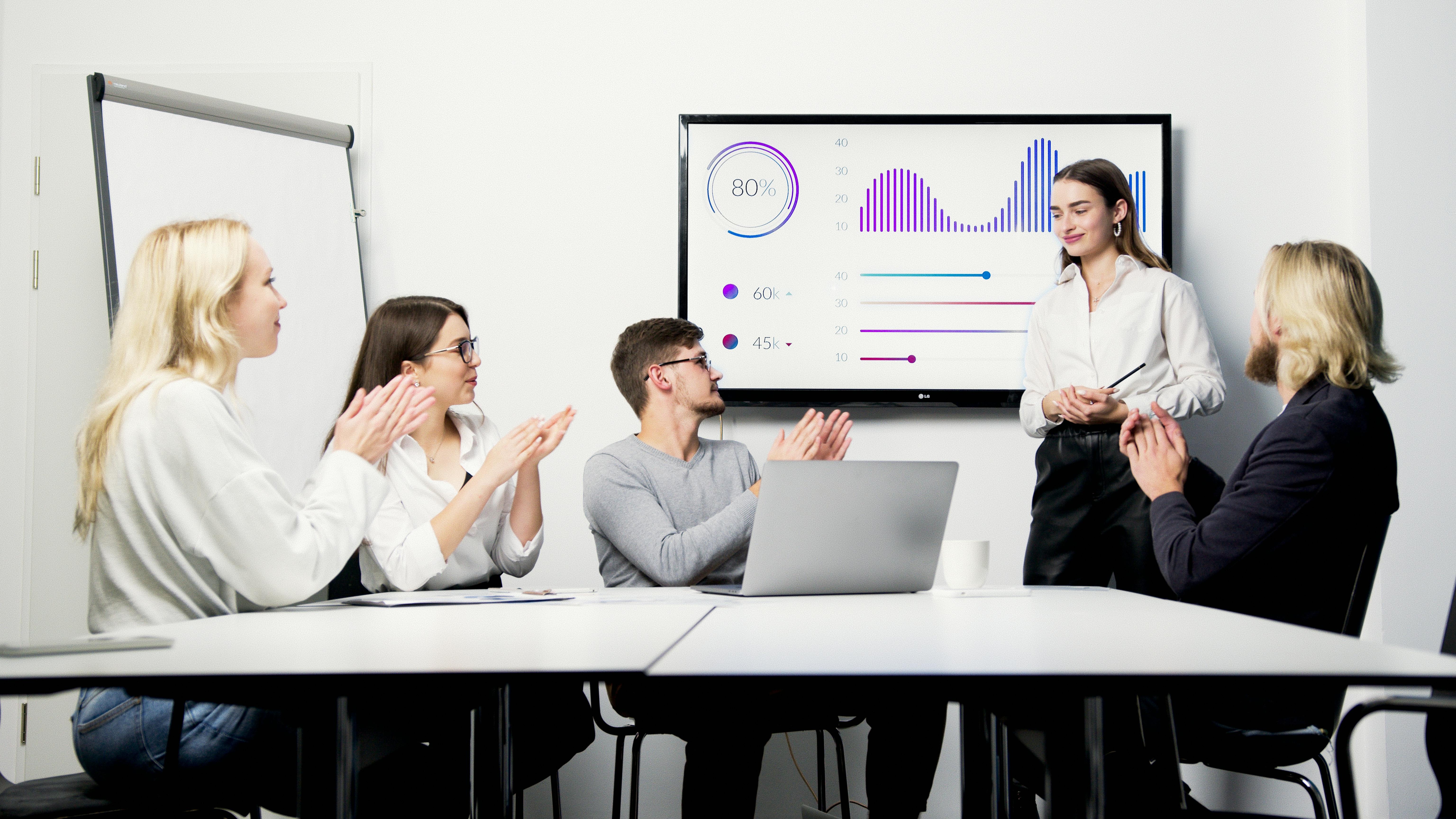 Diverse team collaborates on talent management strategies in modern office.