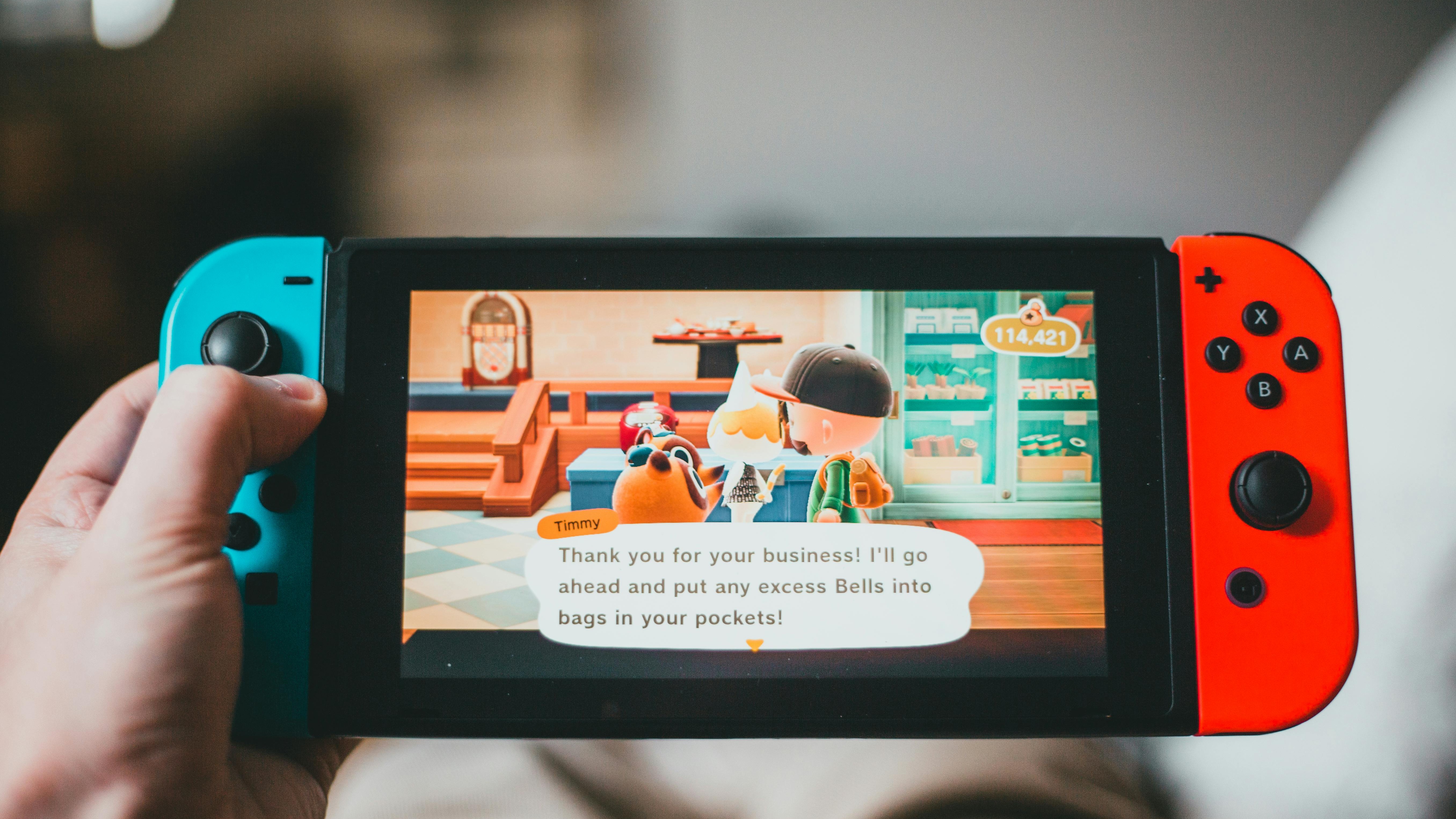 Animal Crossing-themed Nintendo Switch accessory held on wooden table.