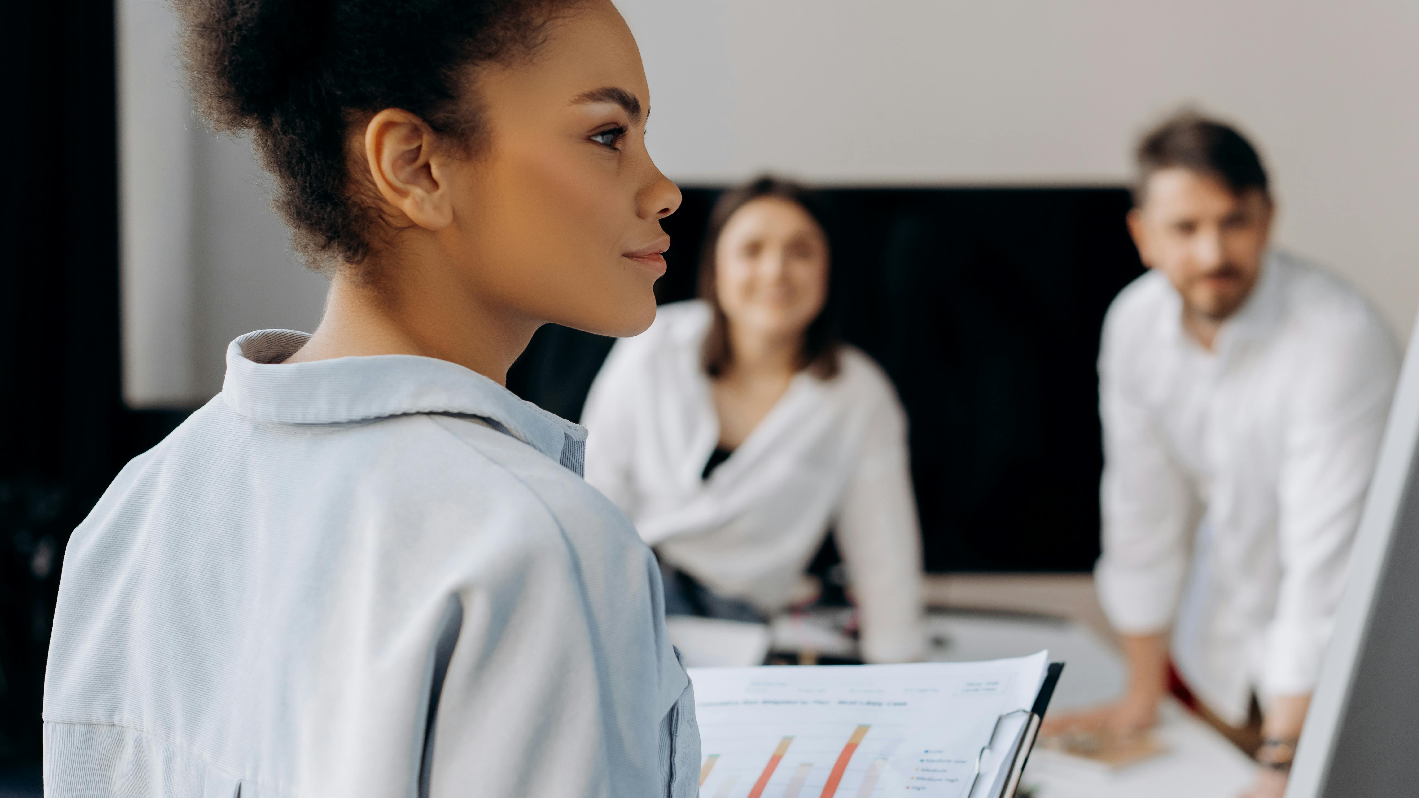 Diverse professionals collaborating in modern office setting with People and Business Resource Groups.