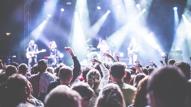 Vibrant crowd capturing moments at a lively outdoor event.