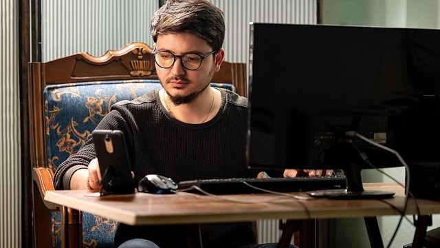 Young man enhancing communication in virtual care through laptop usage.