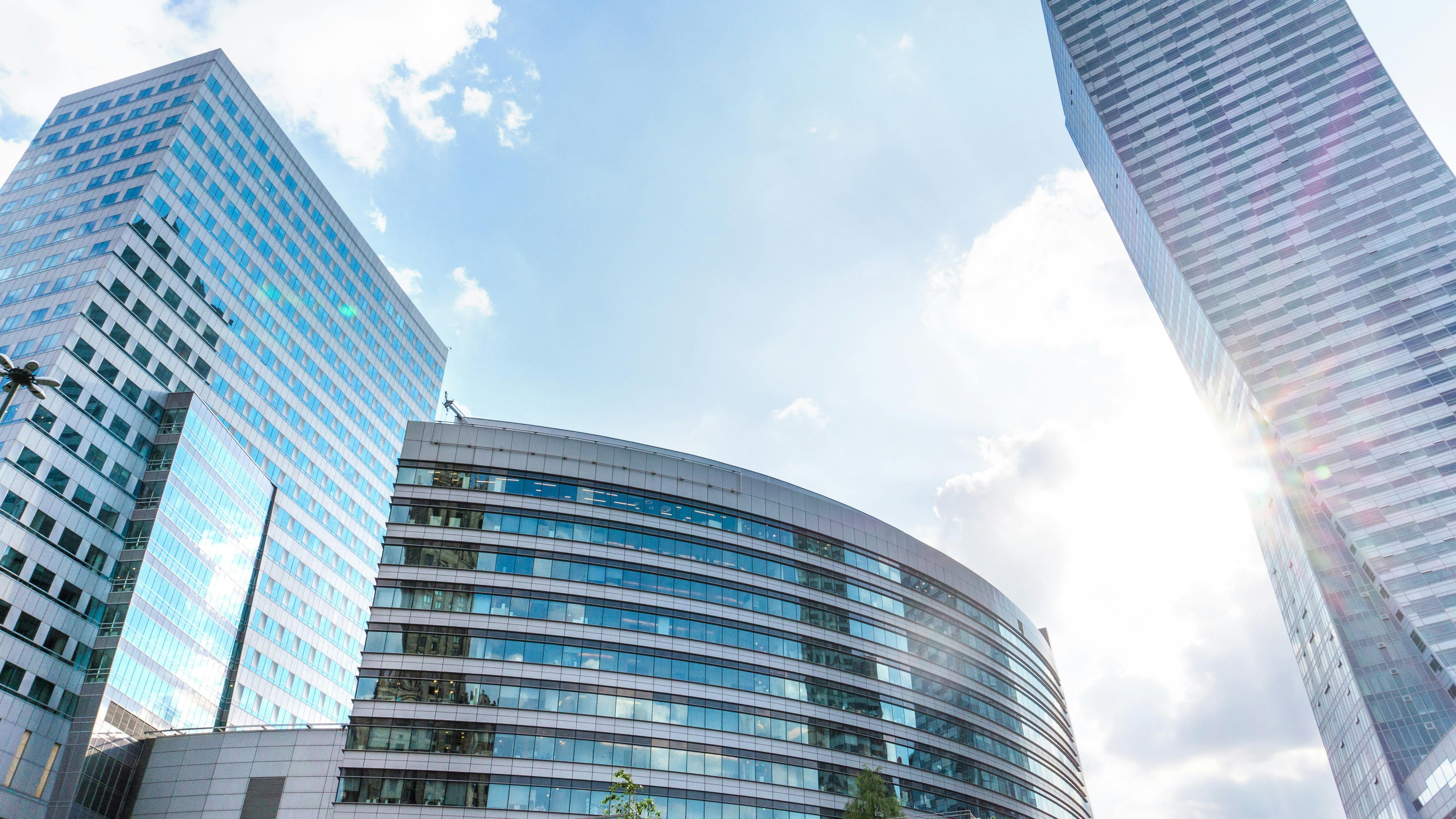 Office building with neon lights representing organizational silos and AI.