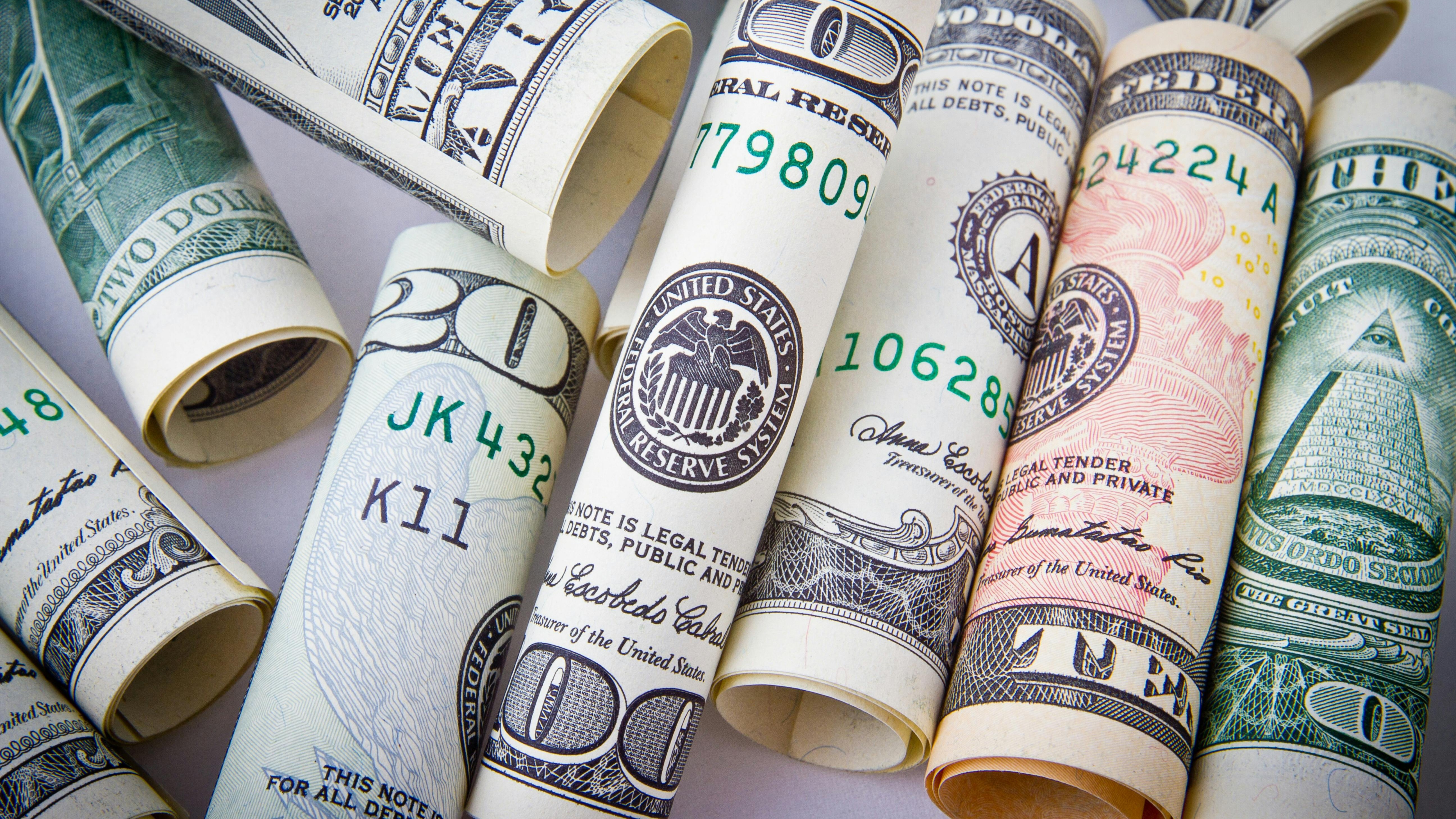 Investigative report on unpaid salaries at CJF America with dollar bills background.