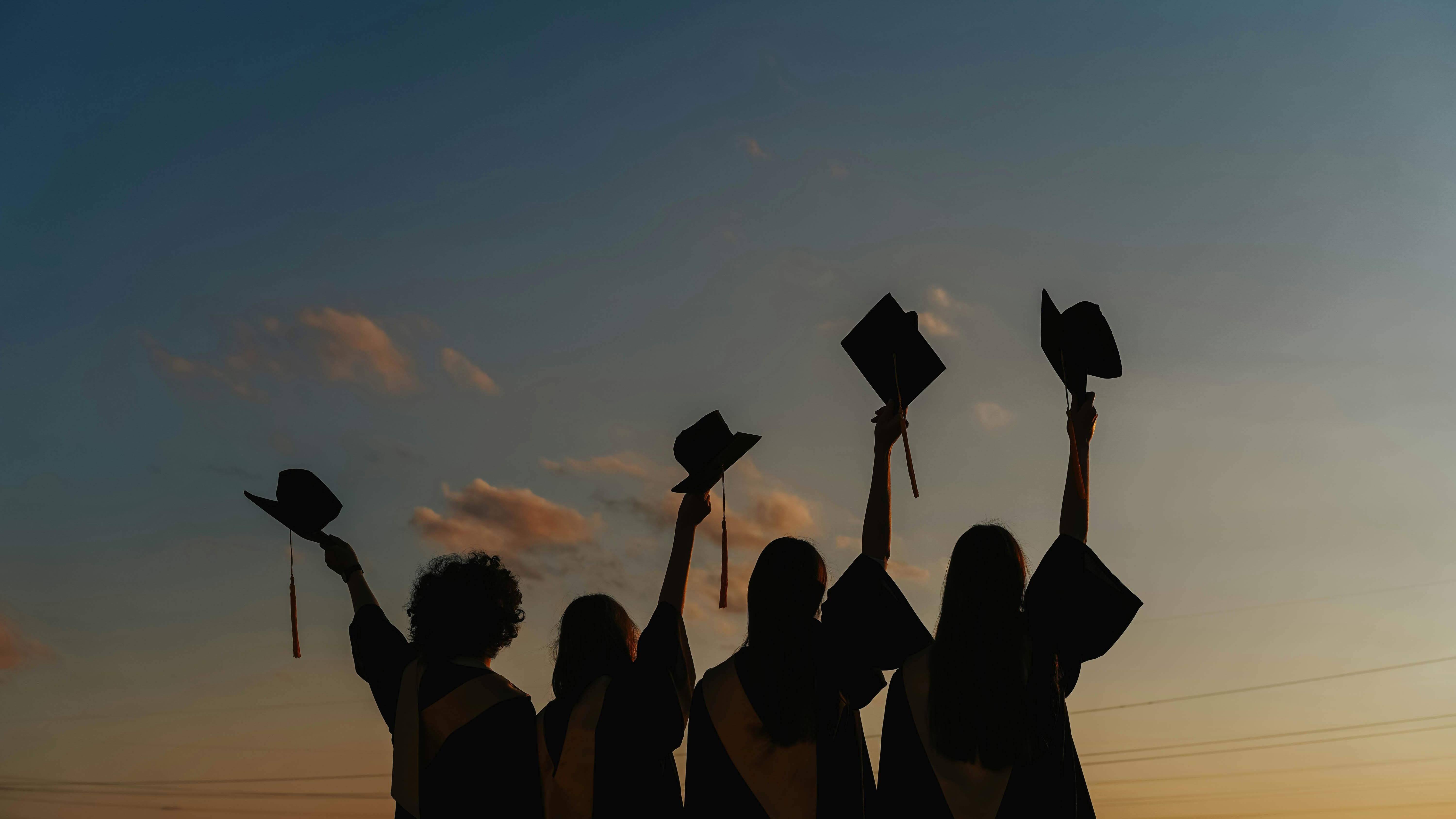 Graduates in caps and gowns, symbolizing student loan stress impact on employee performance.