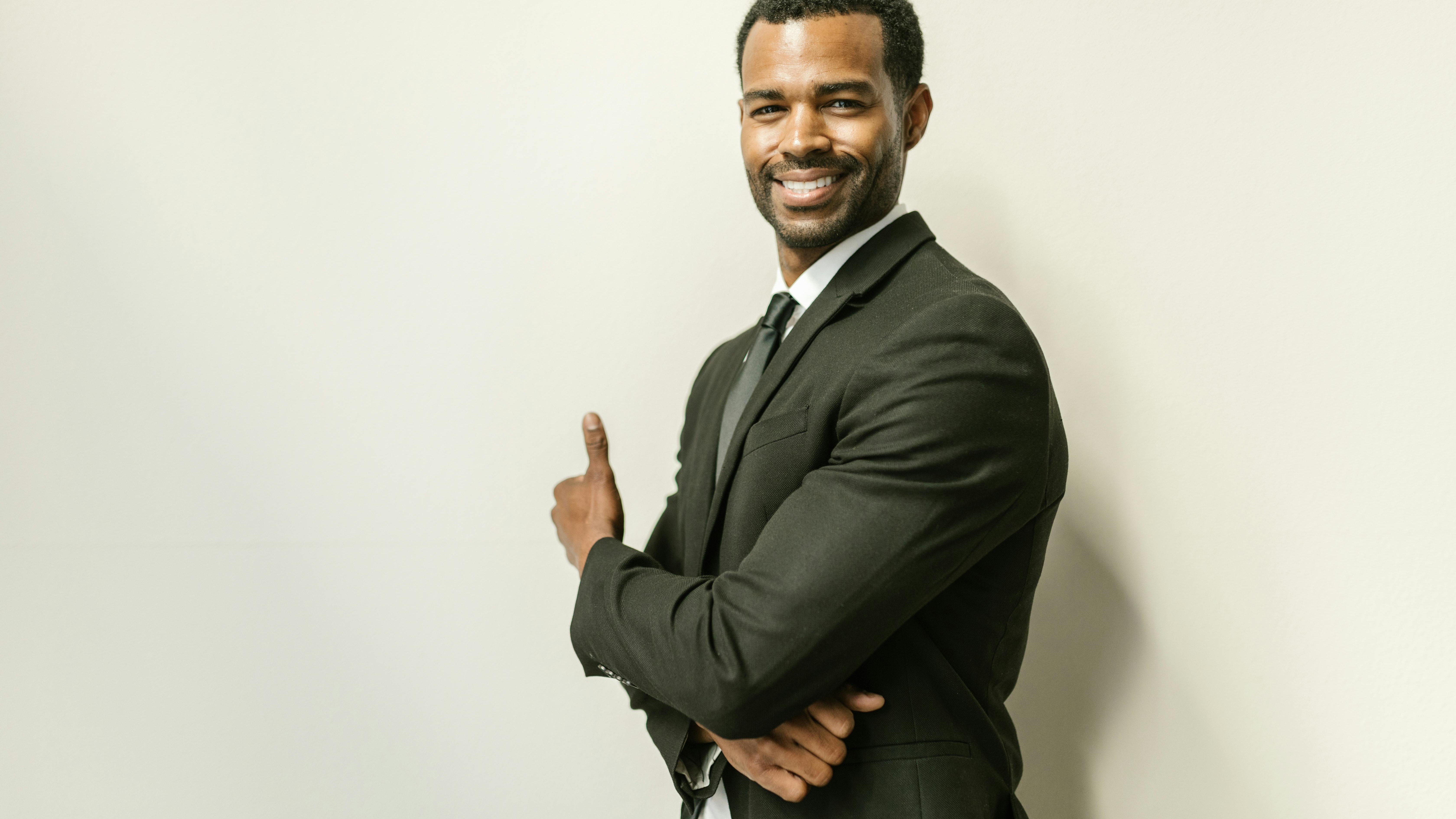 Confident business professional smiling indoors, business scaling strategies.