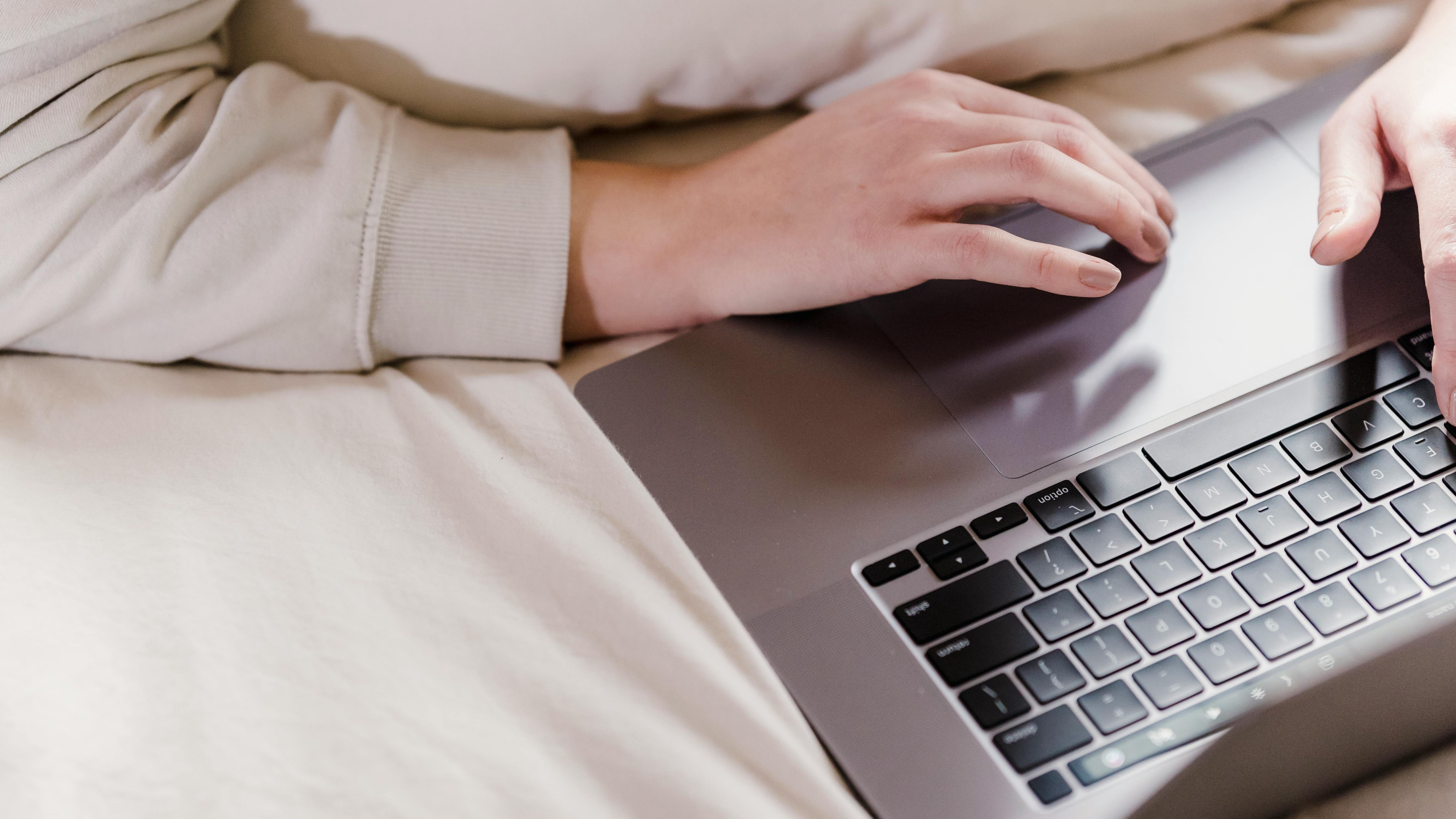 Cheerful woman enjoying T-Mobile Home Internet in cozy living room.